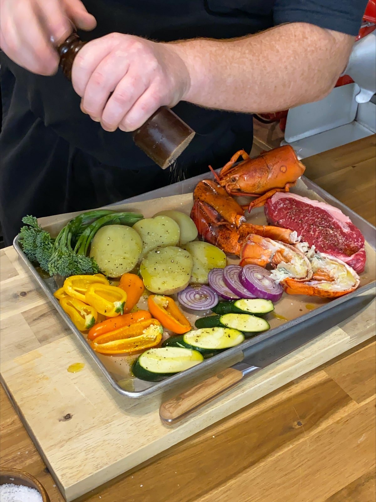 all ingredients on a baking sheet being seasoned.