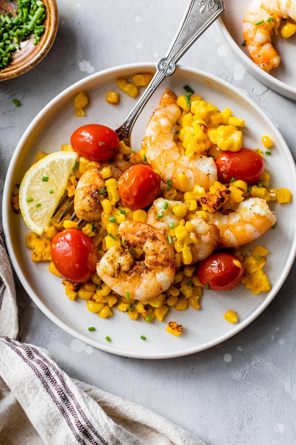Shrimp with Corn and Tomatoes on a plate.