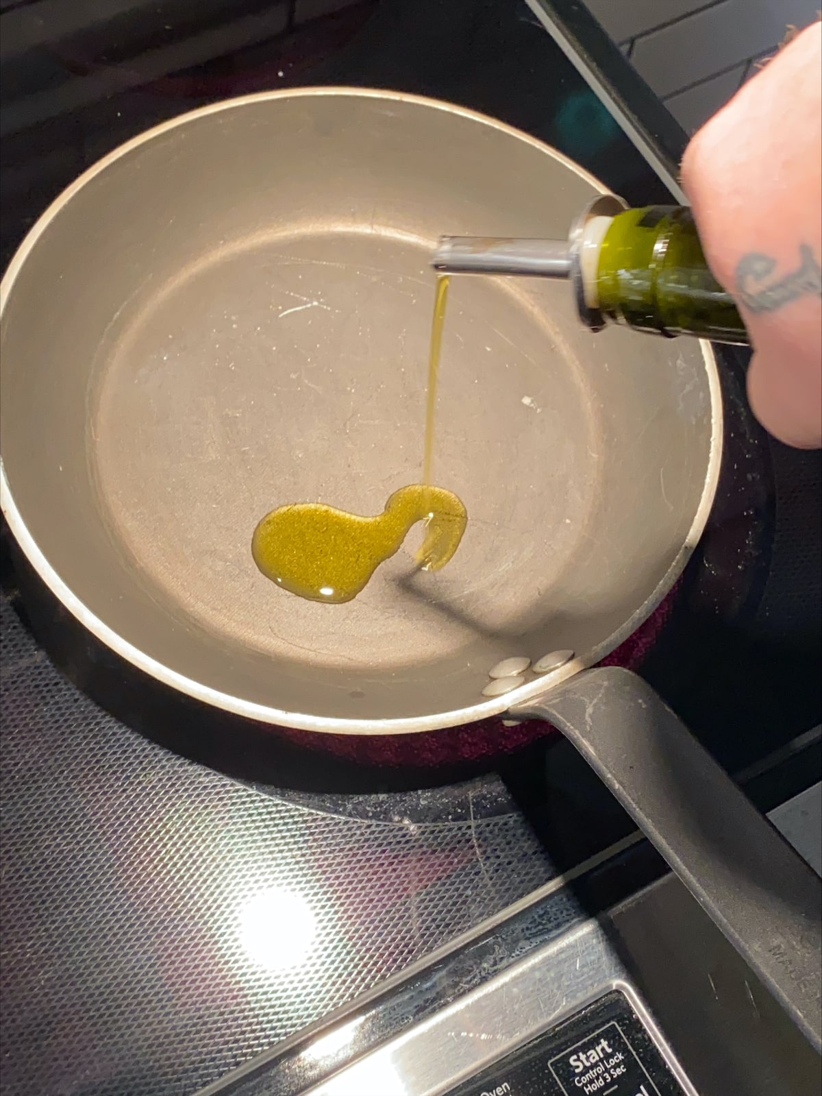 Adding oil to the pan.