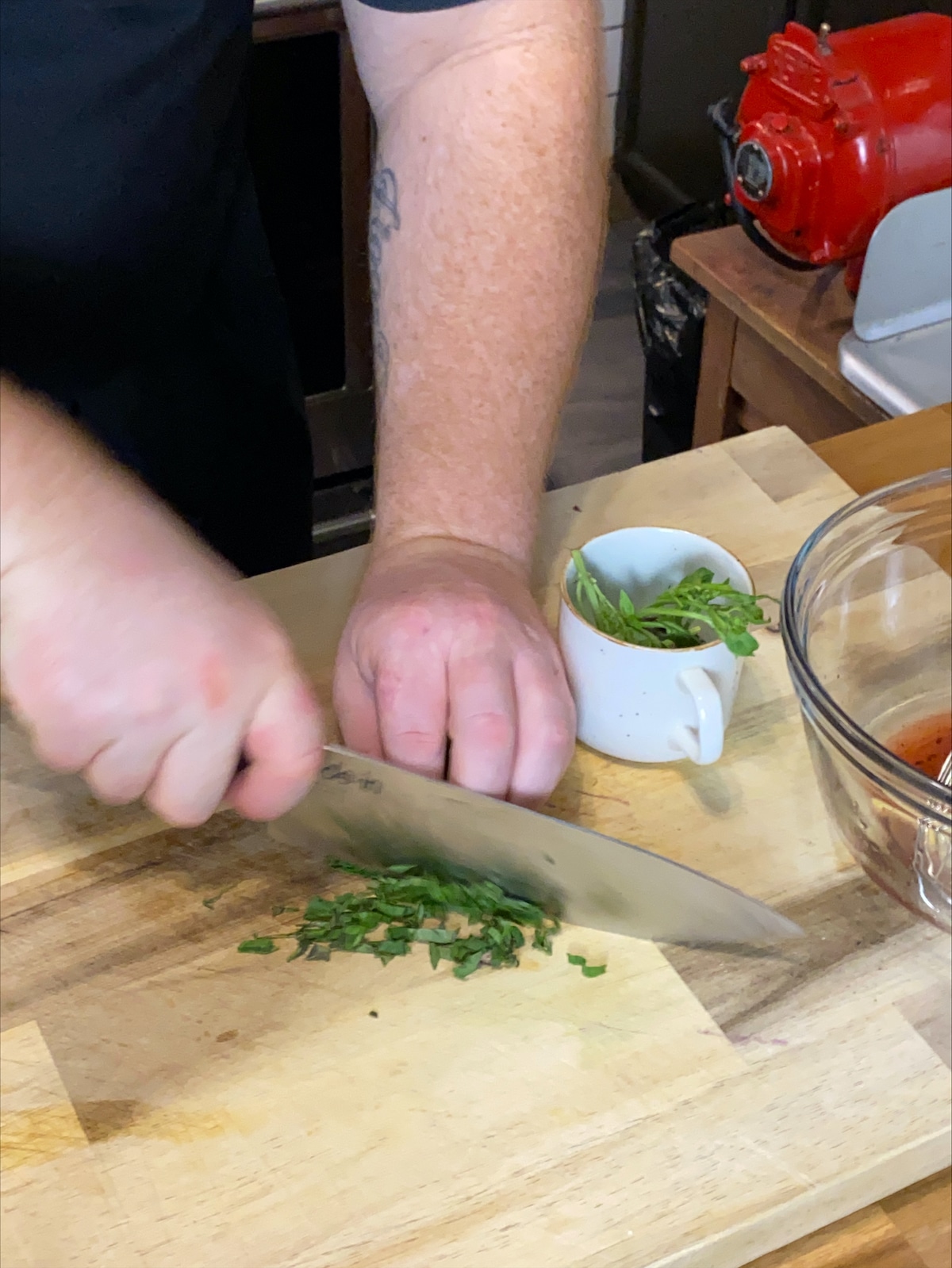 Chopping herbs for the vinaigrette.