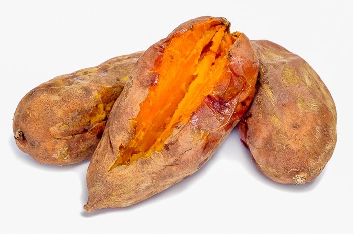 some roasted sweet potatoes on a white background