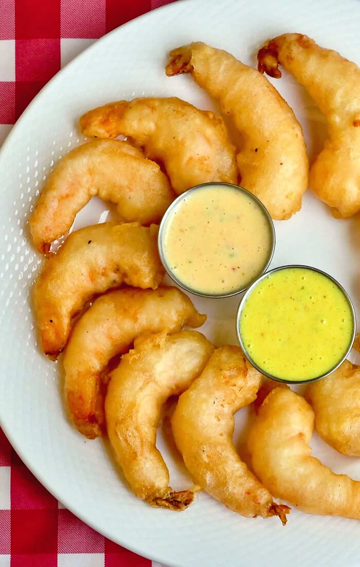 Beer Battered Shrimp photo of a platter of shrimp organized in a semi circle on a white platter.