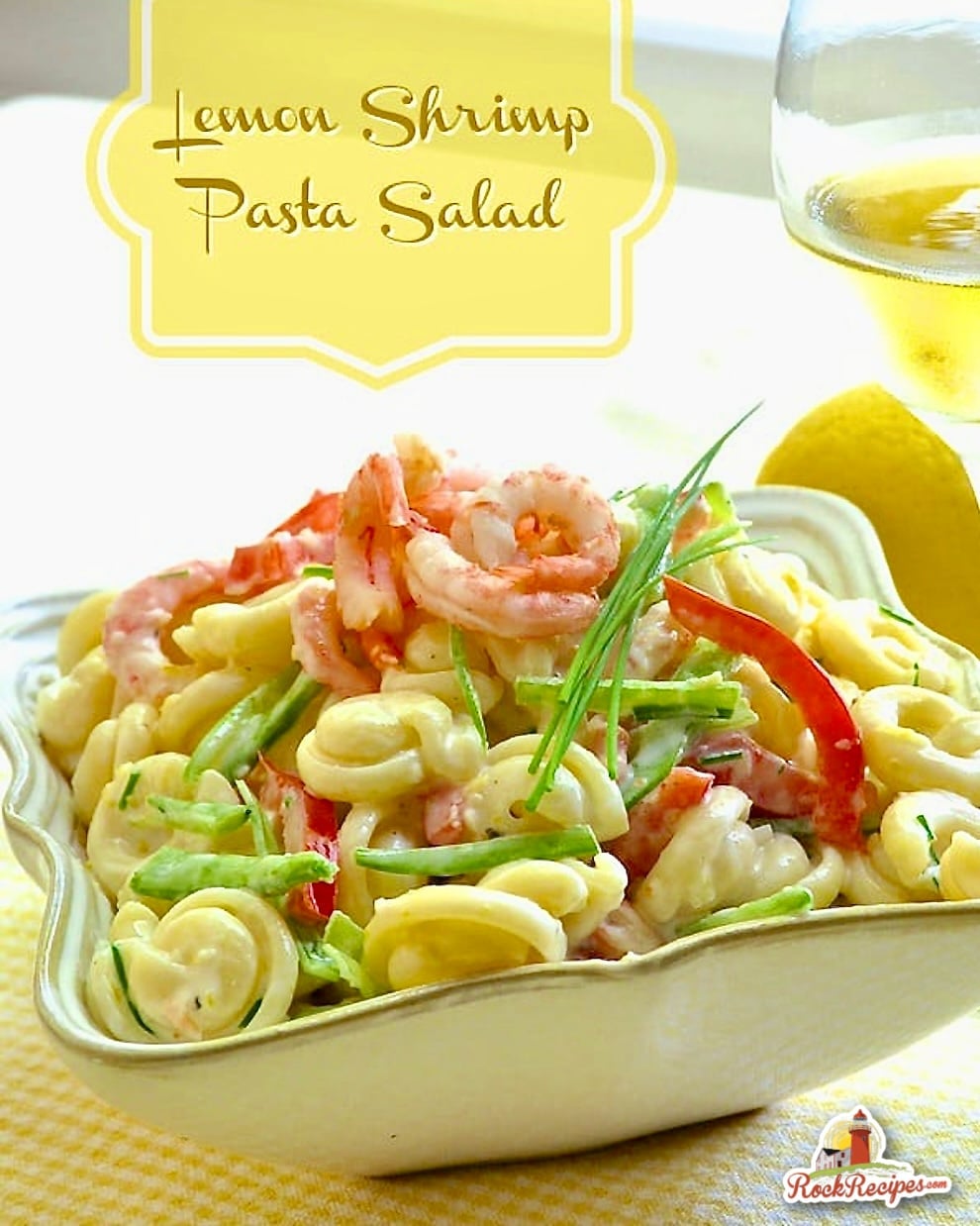 Lemon Shrimp Pasta Salad shown in a square white serving bowl with title text added for social media posts.