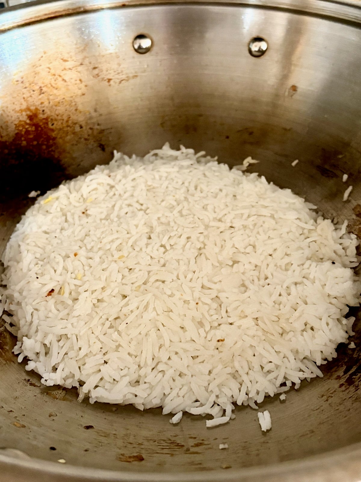 Photo of. rice pressed into a wok.