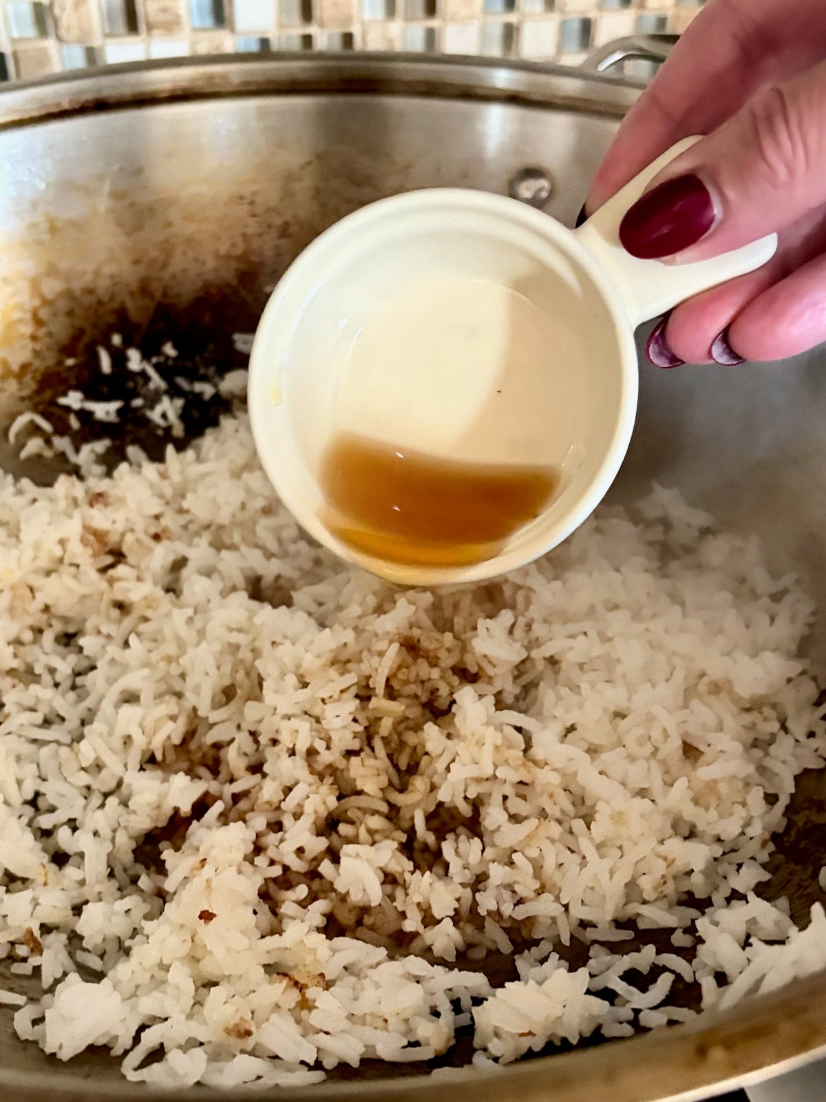photo of soy sauce being added to the rice.
